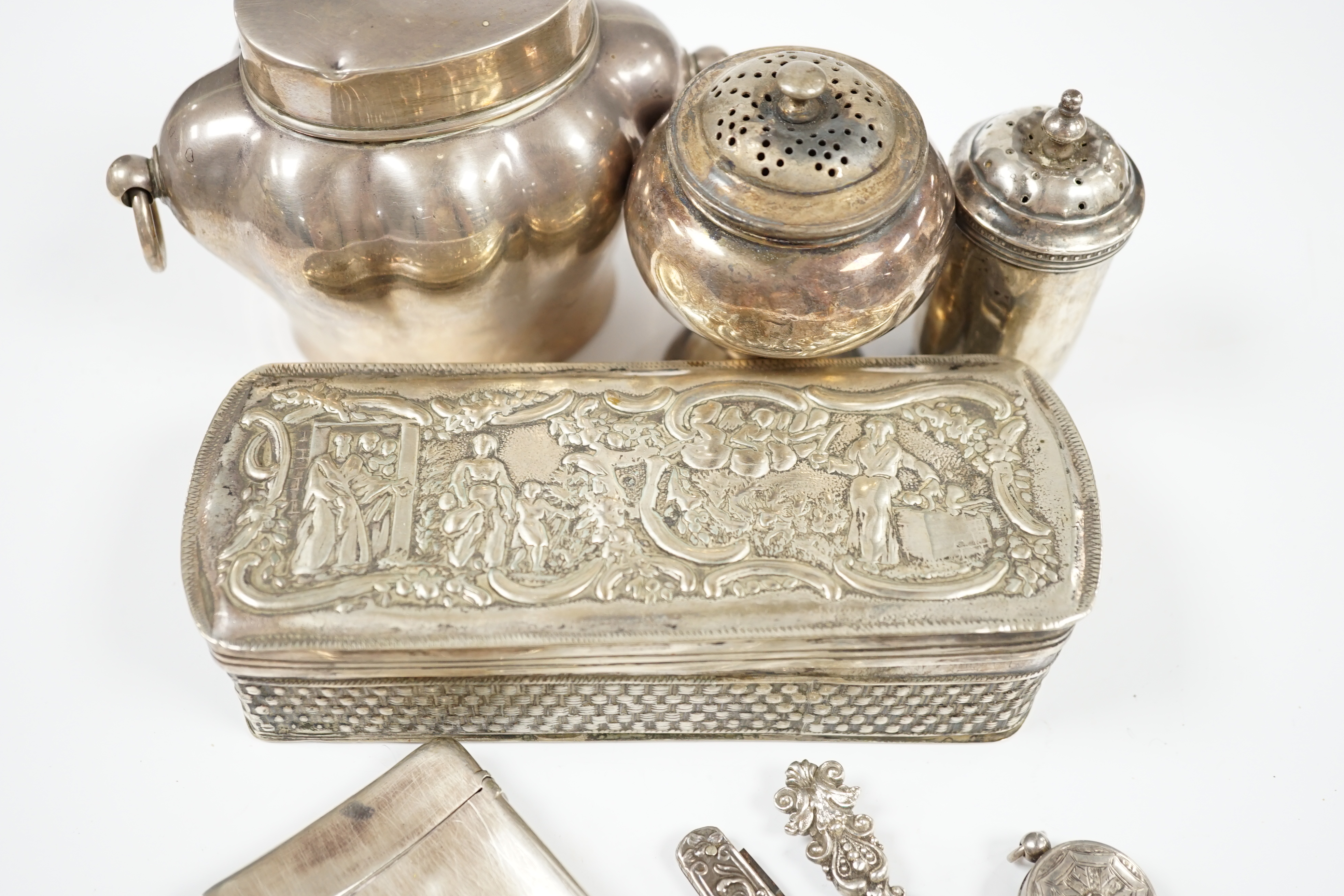 Sundry small silver including an Edwardian silver tea caddy, height 84mm, two silver condiments and four other items including a silver cased tape measure, together with a white metal trinket box. Condition - poor to fai